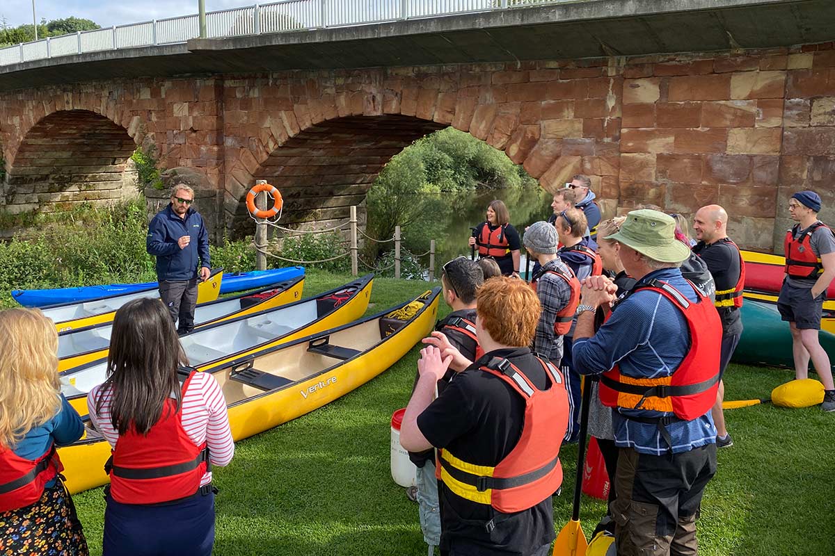 The team learning how to canoe