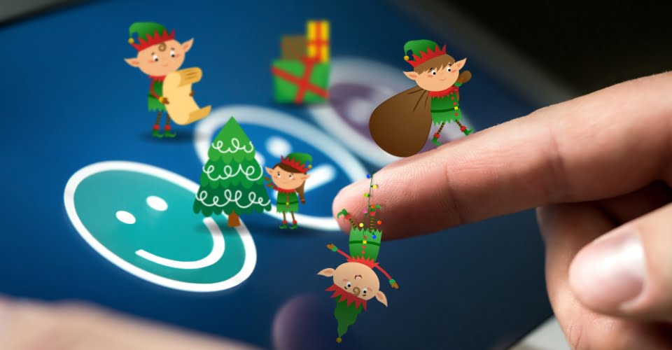 Cheeky Christmas elves on an image of a finger pressing a smiley face on a touch screen
